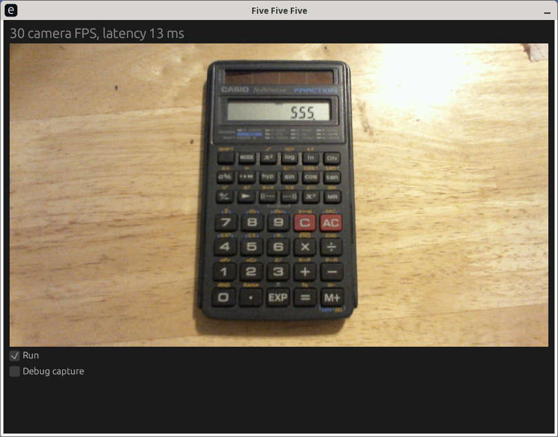 The five_five_five GUI showing a live webcam view of a pocket calculator. The calculator is showing the number "555"