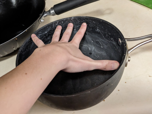 A 9-inch wide pot for boiling pasta. I'm using my hand to measure how wide it is.